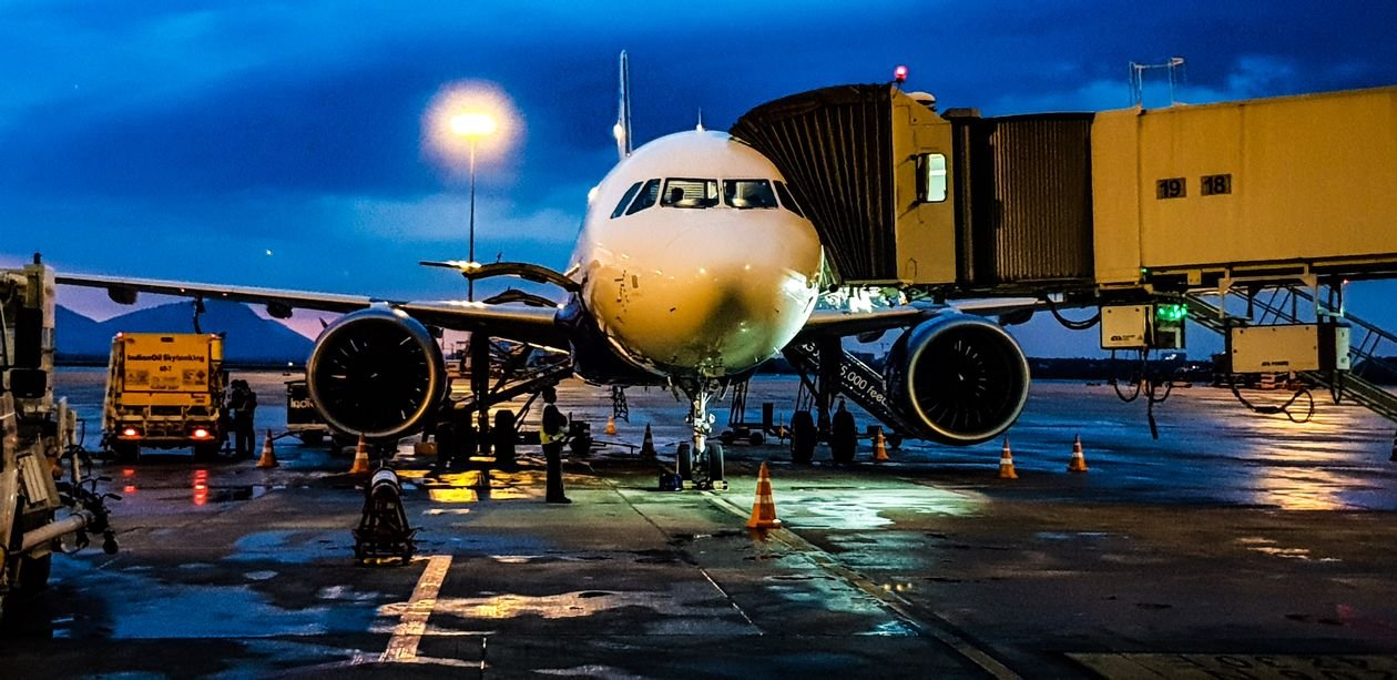 A passenger aircraft at the gate ready for boarding, with cabin crew preparing to welcome travellers on board
