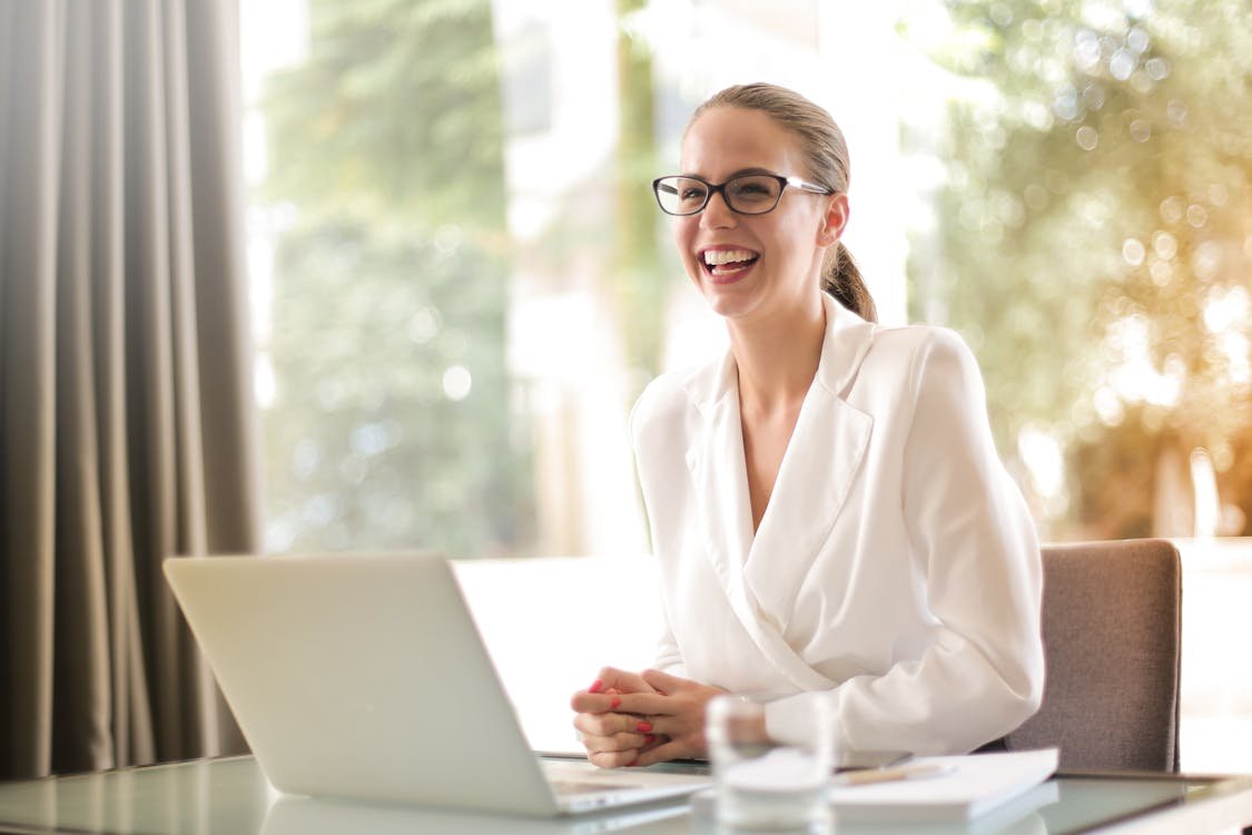 Professional reviewing a polished English CV on a desk beside a laptop and notebook