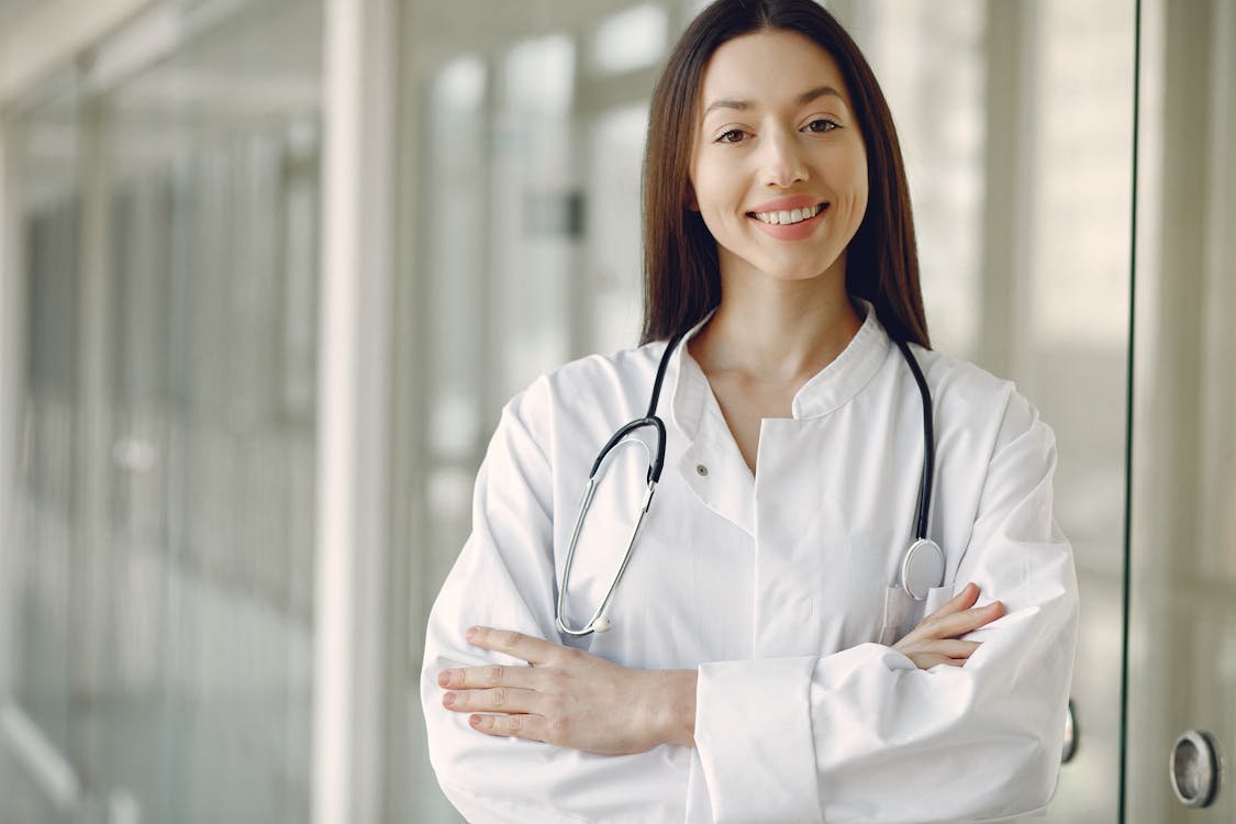 Healthcare professional reviewing a patient's chart in a clinical setting, illustrating the importance of clear medical English at the bedside