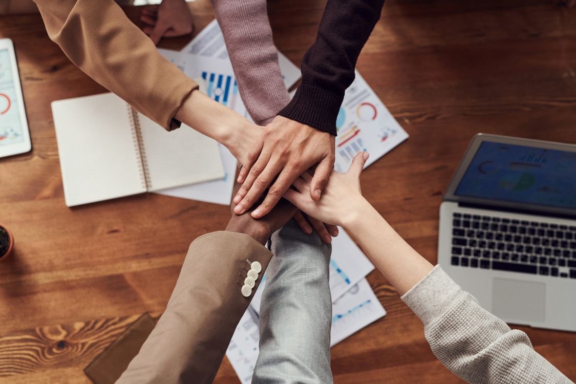 A manager leading a team meeting and speaking confidently in English